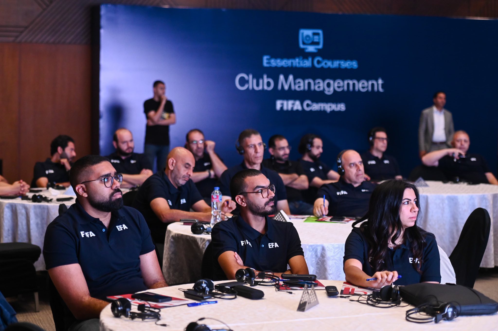May be an image of 11 people and text that says '100 EssentialCourses Essontial Courses Club Management FIFA Campus FEA F A Fih EFA E.T. E'